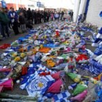 Leicester City football fans pay their respects outside the football stadium, after the helicopter of the club owner Thai businessman Vichai Srivaddhanaprabha crashed when leaving the ground on Saturday evening after the match, in Leicester